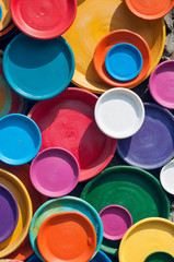 Colorful plates background in sunny day