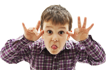 Kid making a face and showing his tongue. Isolated on white background
