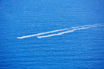 Blue sea ocean with watercrafts wake aerial