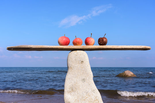 Four apples on seashore