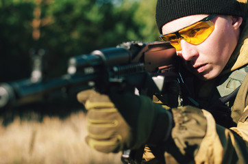 Fototapeta premium soldiers to aim and shoot at a target with automatic weapons