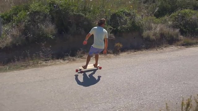 AERIAL: Young male longboarding in Portugal
