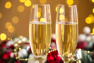 Two champagne glass on christmas bokeh background