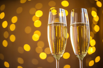 Two champagne glass on christmas bokeh background