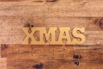 The word "XMAS" on wooden table