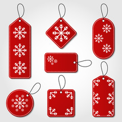 Christmas tag collection in red and white color. Red tag vector set in different shapes with snowflake design and hangers for price tags or gift cards.