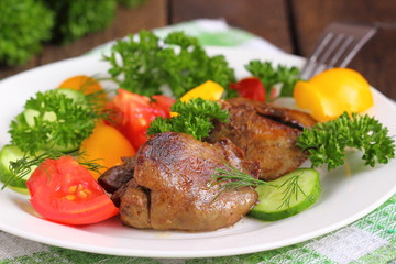 Warm salad with chicken liver, sweet peppers, cherry tomatoes and salad mix