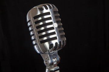 Fototapeta na wymiar vintage microphone over black background