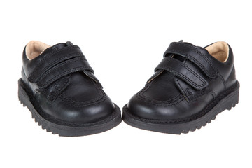 Cute child's black shoes, isolated on a white background