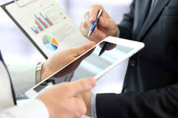 Business colleagues working and analyzing financial figures on a