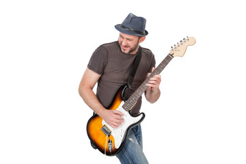 man with hat and beard play on electric guitar with enthusiasm. Isolated on white