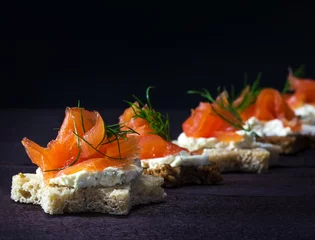 Printed kitchen splashbacks Buffet, Bar Row of festive canapes in star shape with smoked salmon on dark