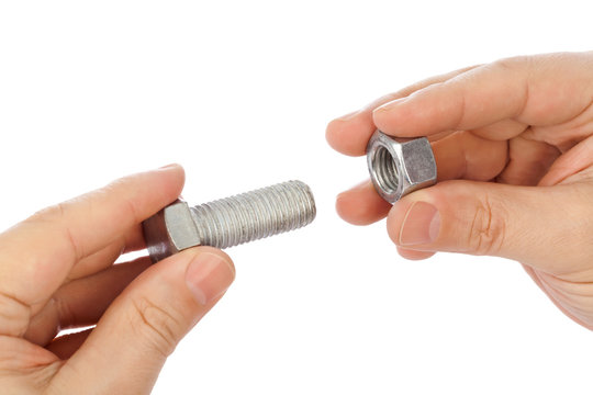 Bolt and nut in hands