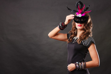Woman with carnival venetian mask on dark
