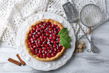 Tart with raspberries, on wooden background