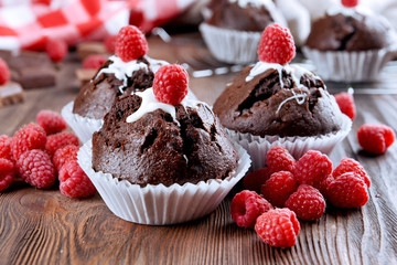 Delicious cupcakes with berries on table close up