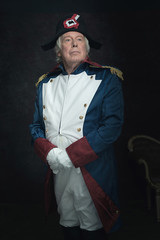 Official portrait of senior man dressed in historical emperor co