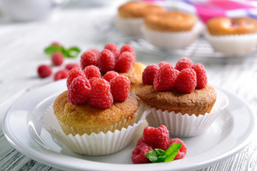 Delicious cupcakes with berries and fresh mint on wooden table close up