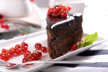 Tasty chocolate cake with berries on table close up
