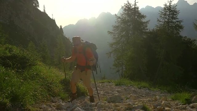 SLOW MOTION: Young man hiking in the mountains