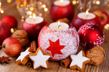 Christmas table decoration with candles in red apples