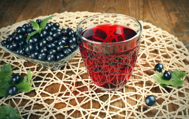 Fresh currant juice with berries on table close up