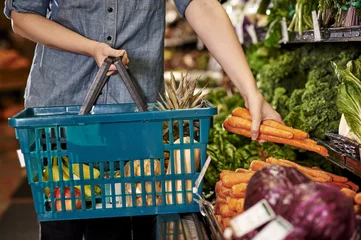 a woman shopping at a grocery store © goodmanphoto
