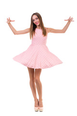 Naklejka premium Full length of sensual woman in short dress dancing against isolated white