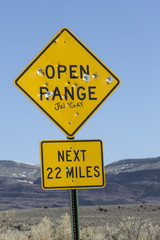 Bullet-riddled road sign, Sand Wash Basin, Colorado, USA