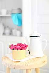 Beautiful flowers in decorative vase on light background