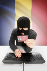 Hacker with flag on background holding ID card in hand - Romania