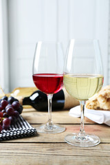 Still life of wine and bread on light background
