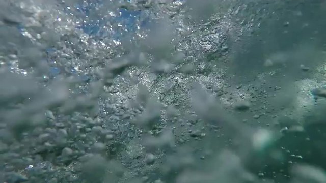 SLOW MOTION UNDERWATER: Pro surfer catching big wave