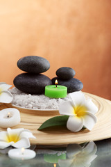 Still life with spa stones on brown background