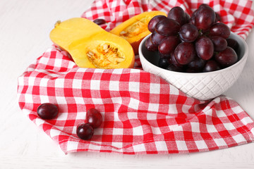 Pumpkin and grapes on table close up