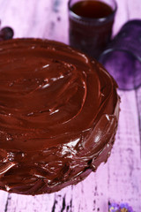 tasty chocolate pie with sweet grape and glass of tea on wooden background