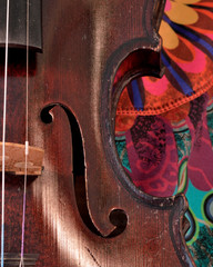 Antique violin closeup against bright print © victoria1988