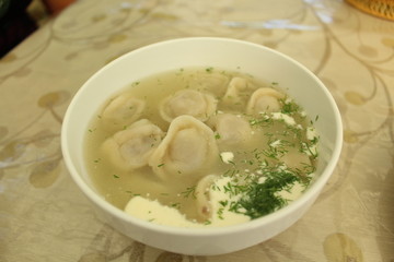 Meat dumplings with crushed herbs on top.