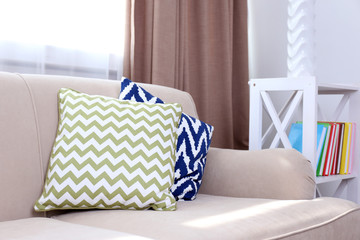Comfortable sofa  with different pillows in the room, close up