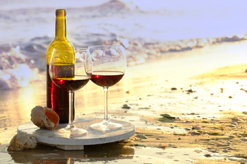 Wine bottle and glasses on the seashore