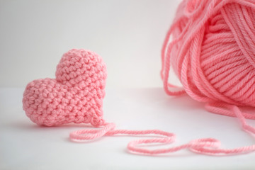 Adorable little heart crocheted by hand. Made with a thread of a thick bulky wool thread. The thread is not cut and still attached to the heart.