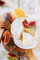 Cheese Board,Camembert with figs and honey and white wine.selective focus.