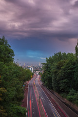 Sunset skyline of central London with storm clouds from Holloway Bridge, UK