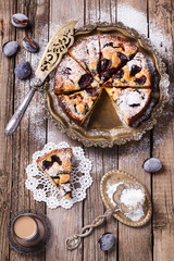 Plum cake with powdered sugar and a Cup of coffee.selective focus