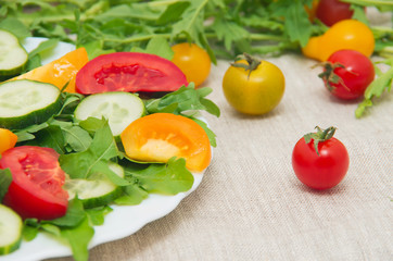 Fresh salad with tomatoes, rucola and cucumbers
