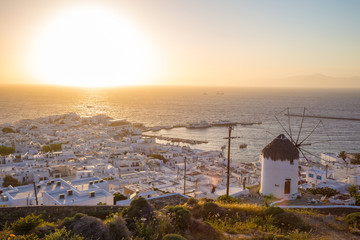 Mykonos town skyline with windmill at sunset - Greece