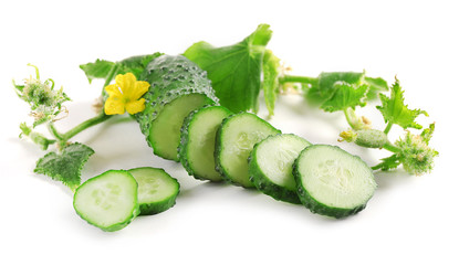 Sliced cucumbers with leafs isolated on white background