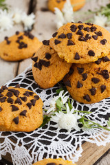 Cookies with chocolate on old books with fresh flowers.selective focus