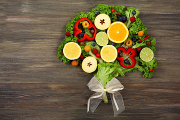 Beautiful bouquet of fruits and vegetables on wooden background