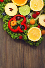 Beautiful bouquet of fruits and vegetables on wooden background, close up